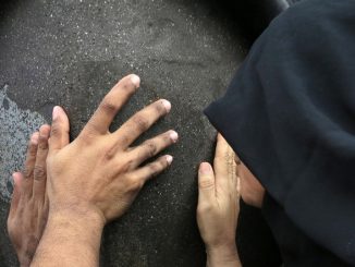 women touching black stone