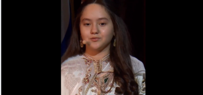 small girl reading his book "My story"